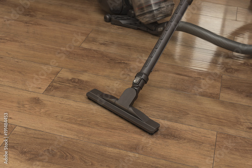 Vacuuming the floor of the laminate.
