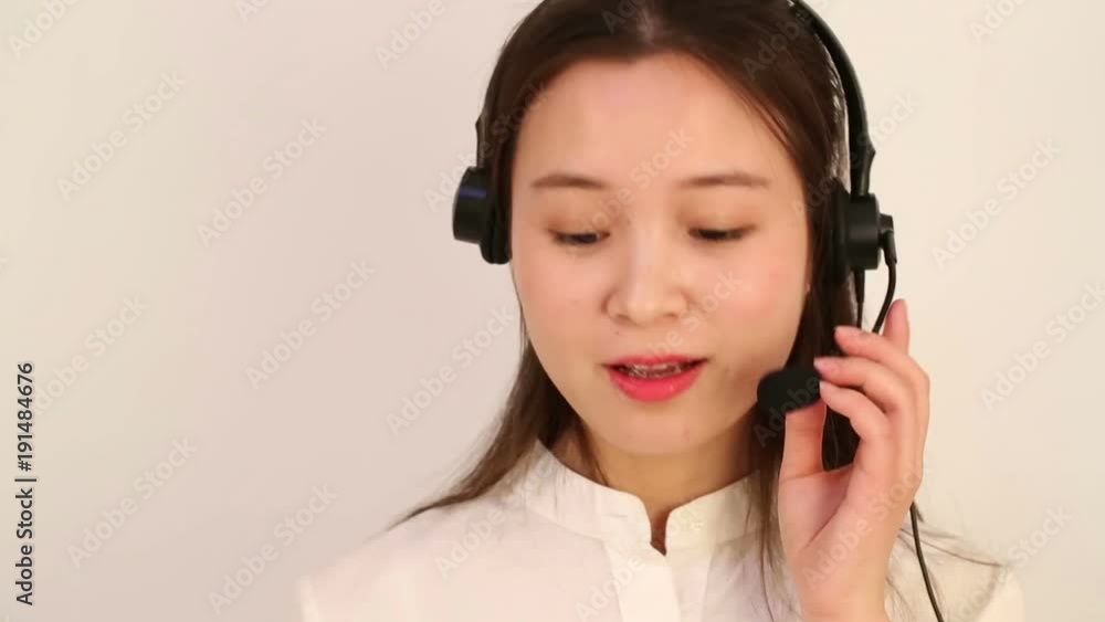 Customer service and support woman talking on the phone against a white background Customer service and support woman talking on the phone against a white background