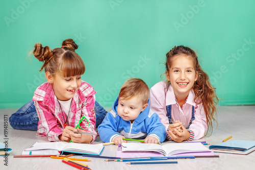 Three children read books. The concept of childhood  learning  friendship  family  school  lifestyle.