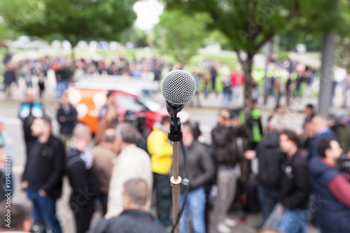 Political protest. Demonstration. Microphone in focus against blurred crowd. © wellphoto