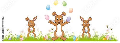 3 cute Easter Bunnies on a green meadow 
