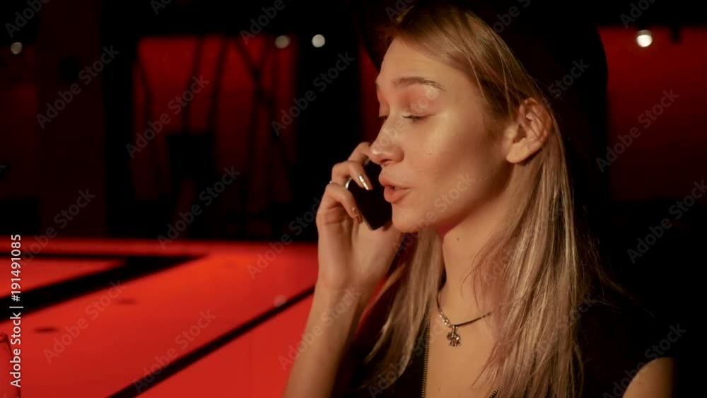 Girl is calling somebody in pub Girl is calling somebody in pub