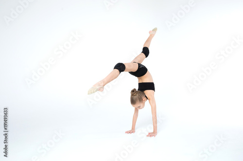 Wallpaper Mural Rhythmic gymnastics caucasian ballet dancer girl in black suite stretching in black costume on white background isolated showing flexible fitness Torontodigital.ca