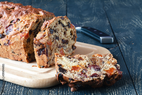 Traditional stollen fruit cake sliced on table