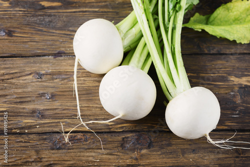 White fresh turnip on the wooden table photo