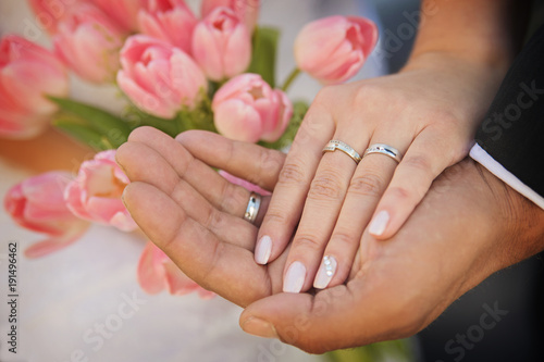 the hands of married couples and the wedding bouquet
