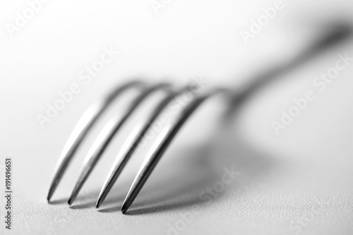 Вилка на столе. Столовый прибор на белом воне. Натюрморт. Fork on a table. Tableware on white to won. Still life 