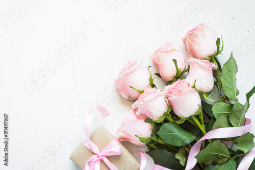 Pink rose at white stone table. © nadianb