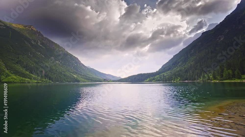 Timelapse at day of lake and mountains among the clouds. 4k HDR H264 photo