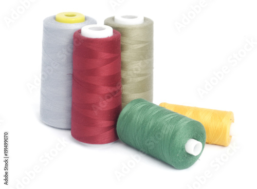 sewing thread in reels isolated on white background