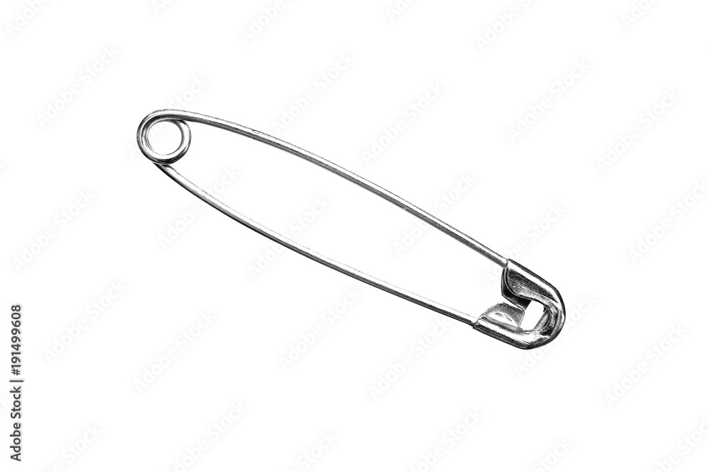 A metal safety pin on a white background. A metal safety pin on a white background.