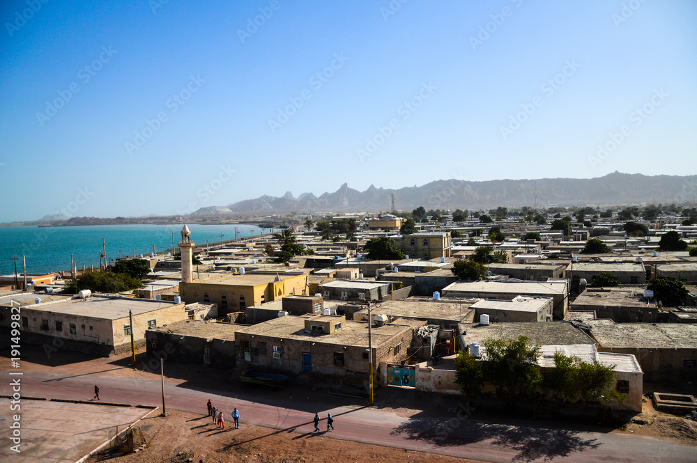 Hormoz, Iran - December 11, 2015: Unidentified people on the street of Hormoz town on Hormoz island in Persian Gulf, Iran - aerial view