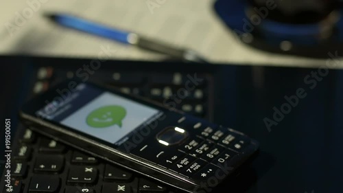 Wallpaper Mural Closeup of man in office answering incoming call on black button mobile phone Torontodigital.ca