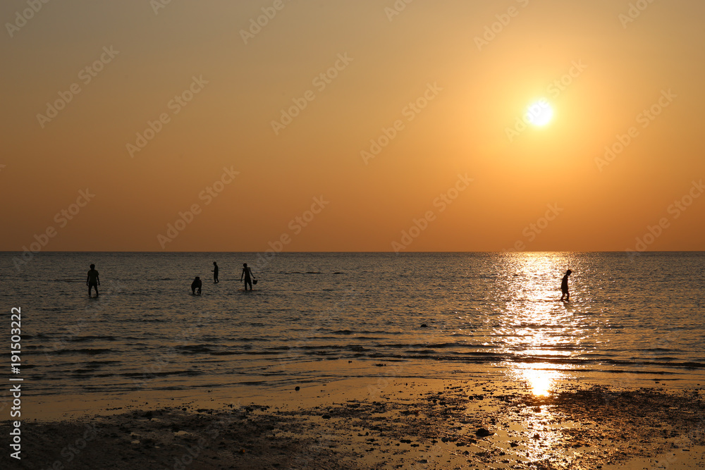 Silhouette of fishermen in the sea at sunset, orange sky. Silhouette of fishermen in the sea at sunset, orange sky.