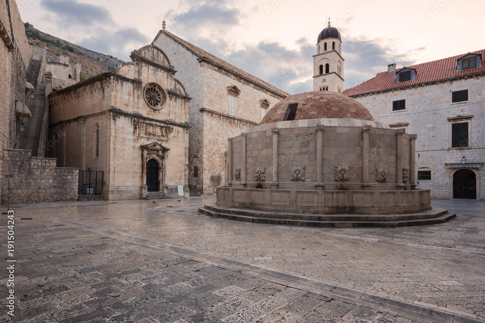Old City of Dubrovnik. Historical town square with big Onofrio fountain, church and the entrance to the city wall, popular tourist destination thanks to the fans of the Games of Thrones, Croatia