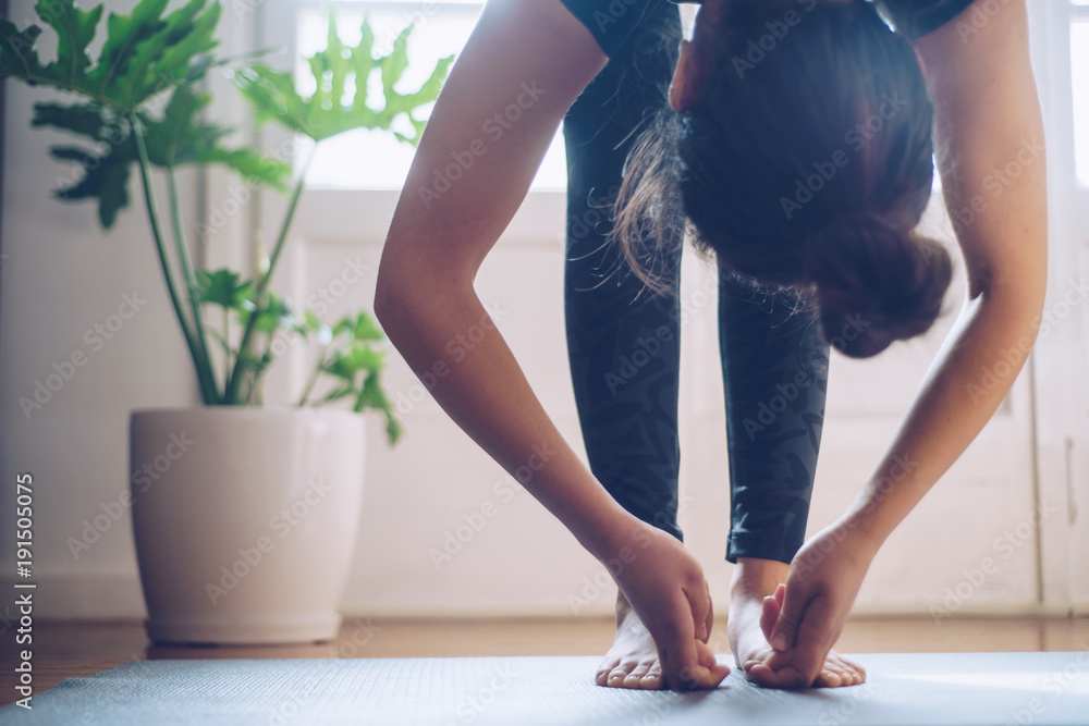 Woman doing yoga in the morning at her home. Woman doing yoga in the morning at her home.