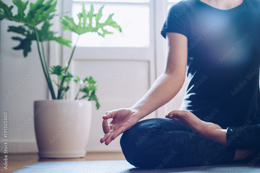 Woman doing yoga in the morning at her home. Woman doing yoga in the morning at her home.