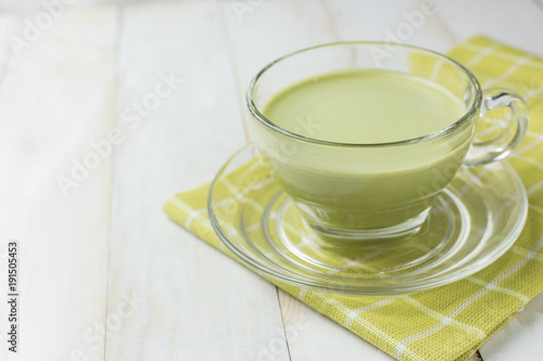 Green tea glass on white wood background.Green tea is beneficial to the body, antioxidants.