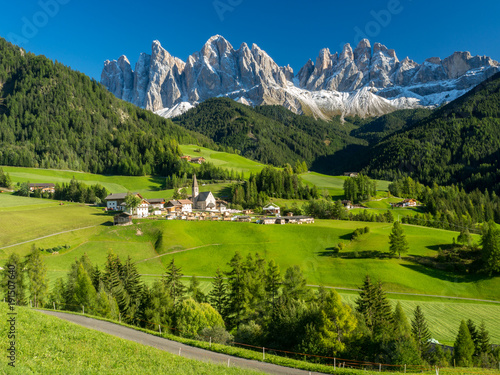 Val di Funes valley, Santa Maddalena touristic village, Dolomites, Italy, Europe. September, 2017. Green grass and blue sky. © ikmerc