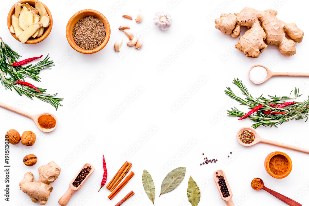 Colorful dry spices in bowls and spoons near ginger, garlic, rosemary, laurel leaf on white background top view copy space - obrazy, fototapety, plakaty 