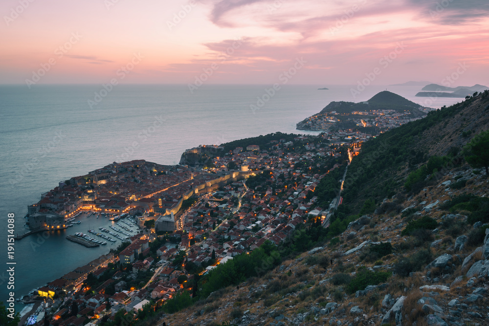 Sunset over Dubrovnik in Croatia, top view from mount Srd, beautiful illuminated cityscape. The world famous and most visited historic city of Croatia, UNESCO World Heritage site