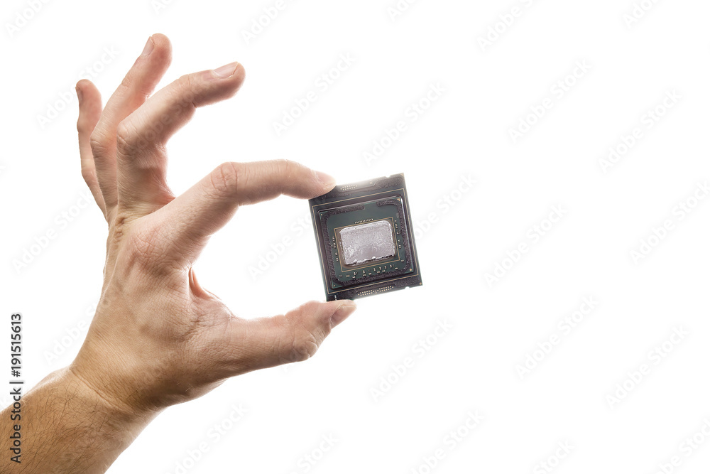 Delidded CPU with old thermal paste and glue in man's hand isolated on white background. Delidded CPU with old thermal paste and glue in man's hand isolated on white background.