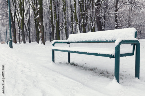 snow-covered bench in the parks.
