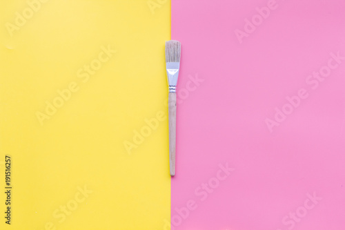 Empty steel fork on yellow and pink background top view copy space © 9dreamstudio