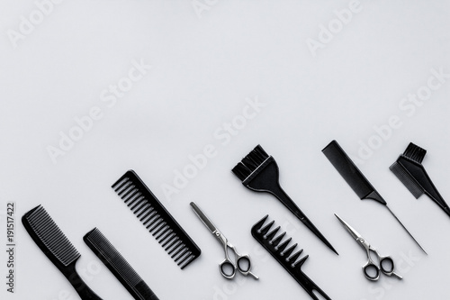 Beauty saloon equipment. Hairdress, haircut. Combs, sciccors, brushes on grey background top view copy space