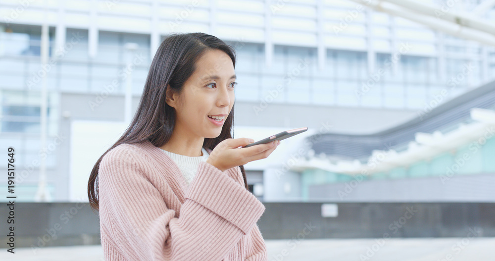 Woman sending audio message on cellphone Woman sending audio message on cellphone