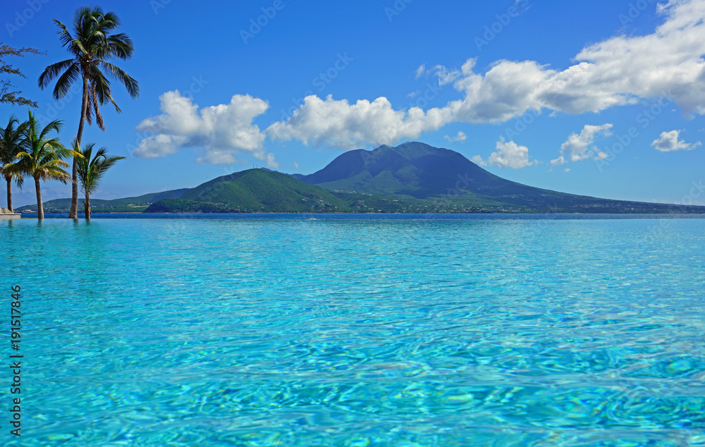 View of the Nevis Peak volcano from a swimming pool in Christopher Harbour, St Kitts 