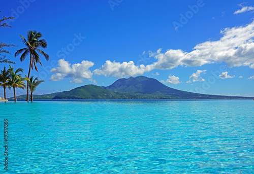 View of the Nevis Peak volcano from a swimming pool in Christopher Harbour, St Kitts 