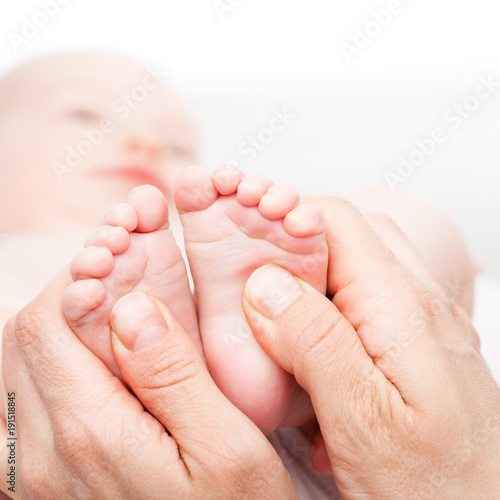 Little baby receiving chiropractic or osteopathic foot massage