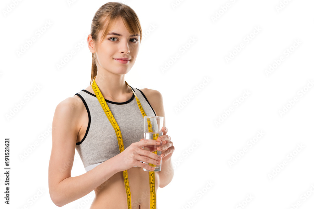 young slim woman wih measuring tape holding glass of water isolated on white young slim woman wih measuring tape holding glass of water isolated on white