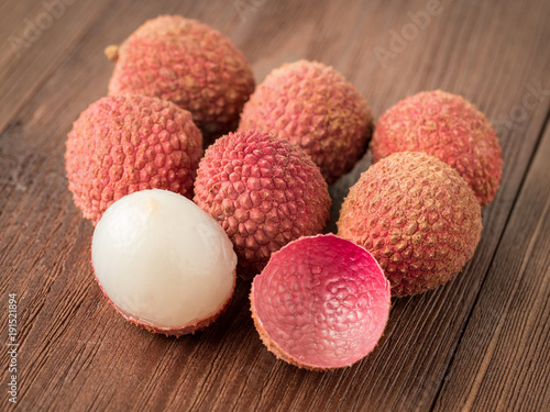 fresh ripe litchi fruit on a wooden table, macro, side view.