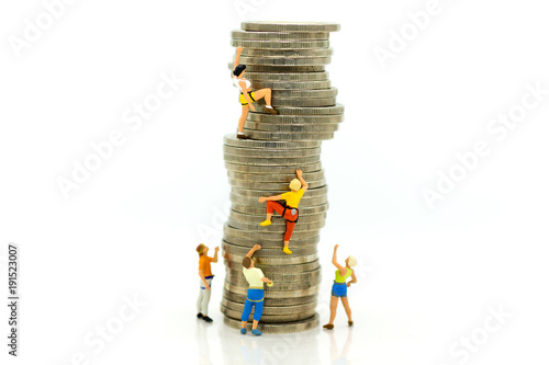 Miniature people: Climbers are climbing coins. Image use for moving forward to success, business concept.