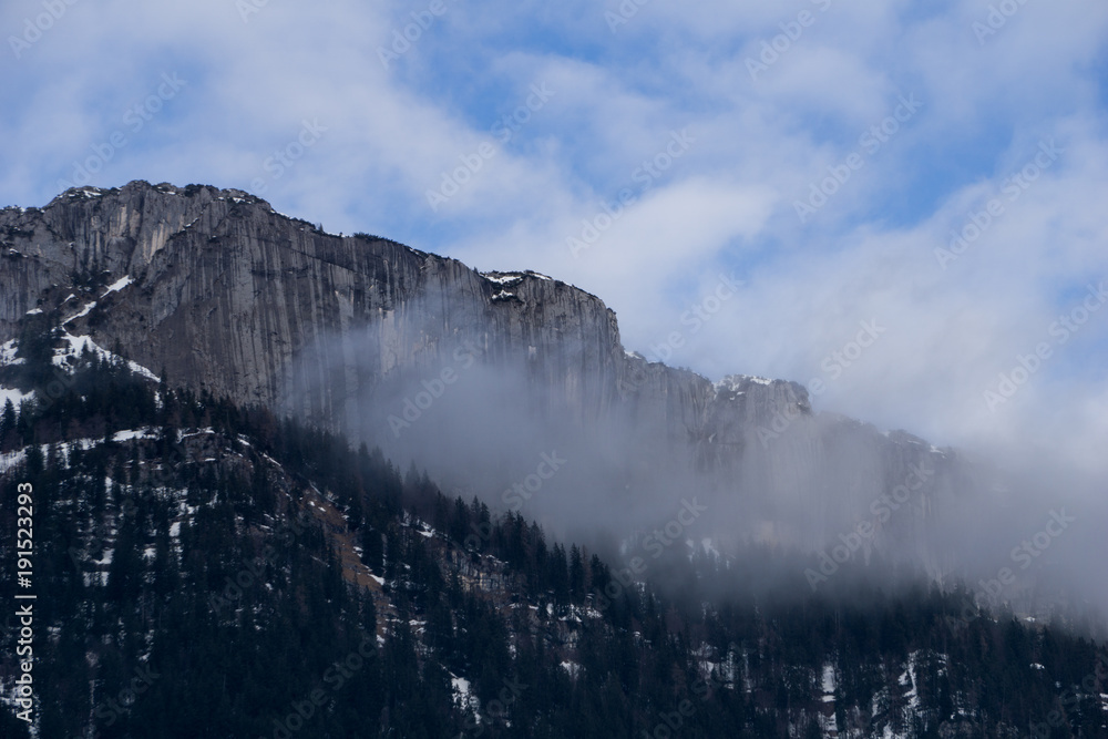 Clouds hitting a vertical stone wall in the Austrian Alps