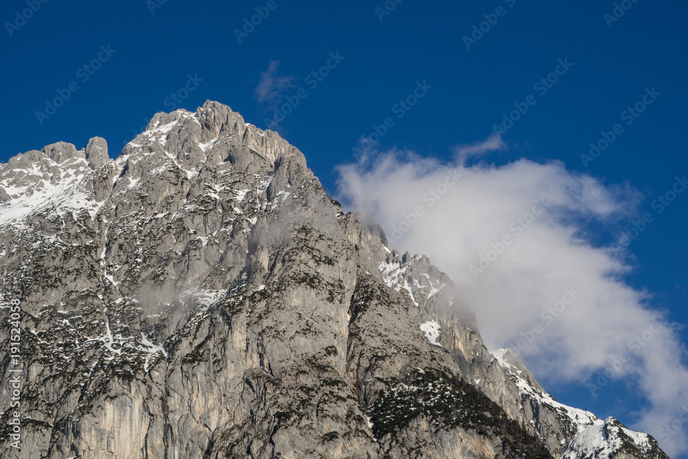 Rugged mountain top standing tall in the winter sun's light
