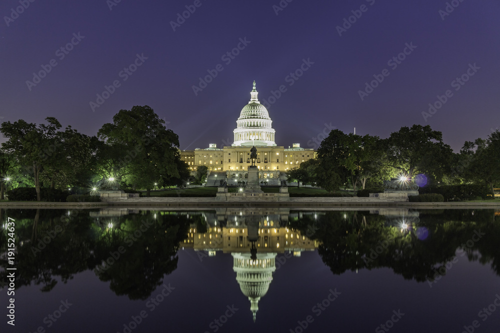 The United States Capitol Building, seen from reflection pool on dusk. Washington DC, USA.