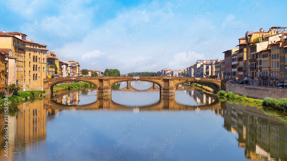 Famous landmark of Florence is the Bridge Trinity. Stone Bridge spanning the river Arno. The oldest elliptic arch bridge in the world. Italy, June 2017. Ponte Santa Trinita.