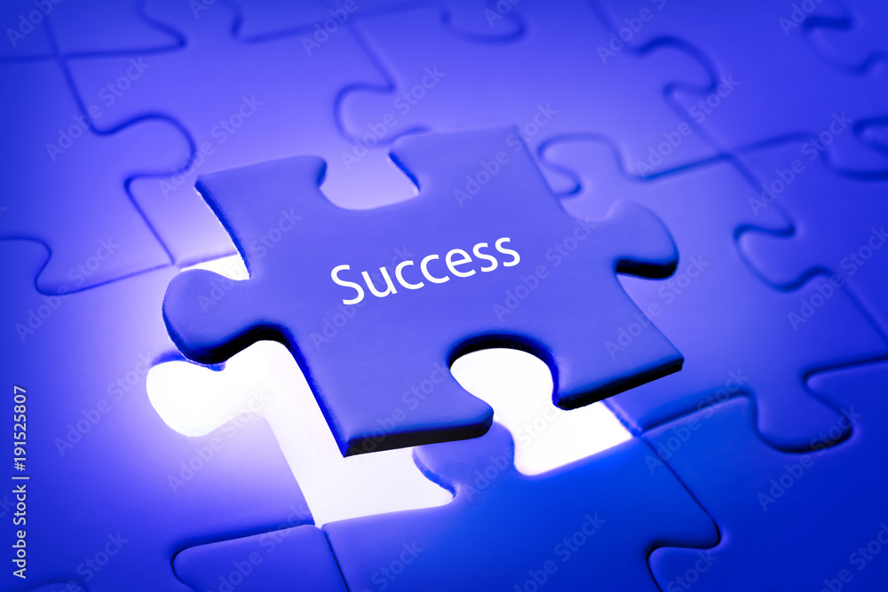 Fototapeta premium Placing last piece of jigsaw puzzle