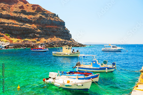 Traditional greek boats in the port of Santorini island, Greece.