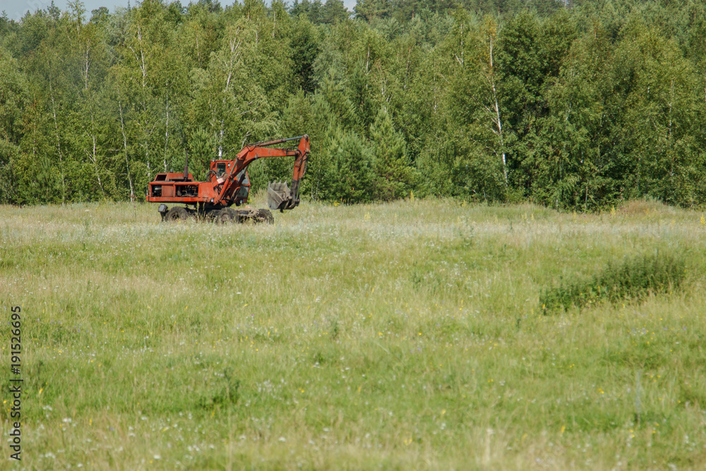 Fototapeta premium excavator working on a meadow.