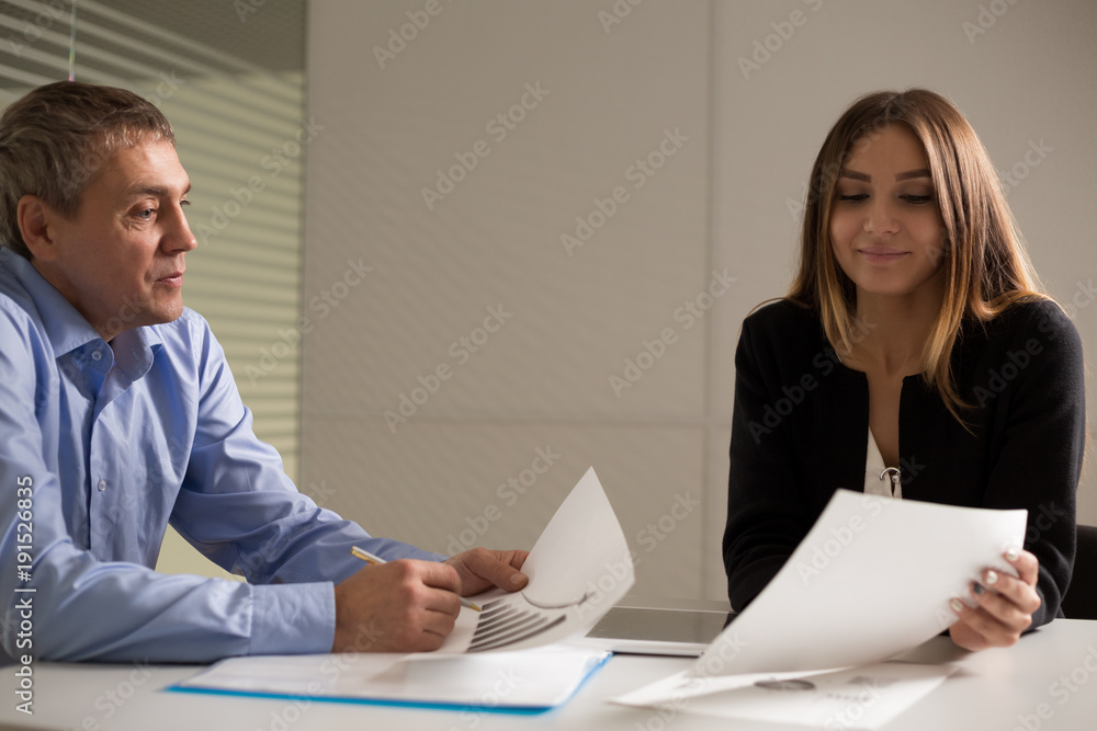 a man and a woman work in an office and talking