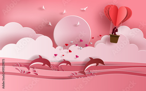Cute couple in love hugging, staring at each other's eyes and standing inside a basket of an air balloon, traveling across the ocean, paper art style, flat-style vector illustration.