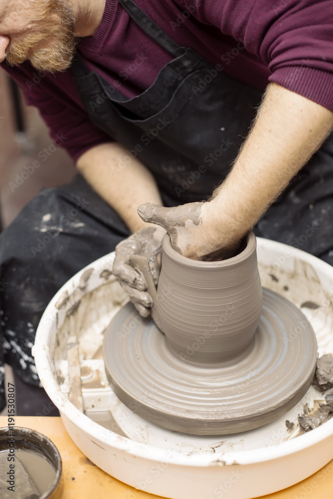 Artist makes clay pottery on a spin wheel Artist makes clay pottery on a spin wheel