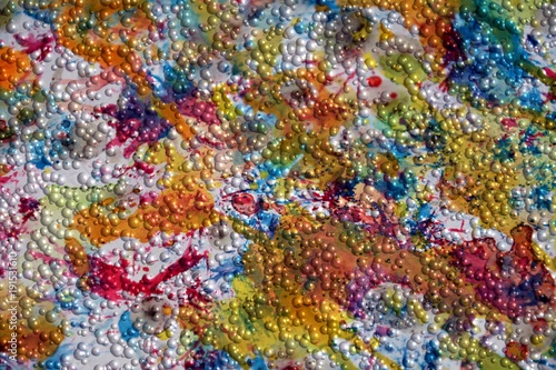Small bubbles on watercolor paint colorful abstract background, plastic like texture