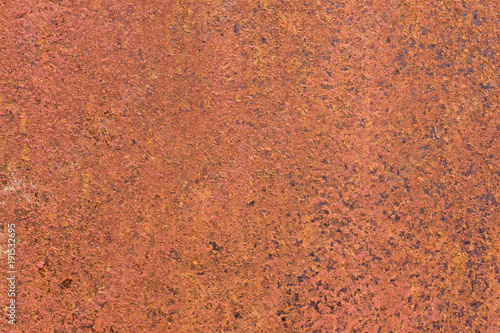 Rusty yellow-red textured metal surface. The texture of the metal sheet is prone to oxidation and corrosion. Grunge background