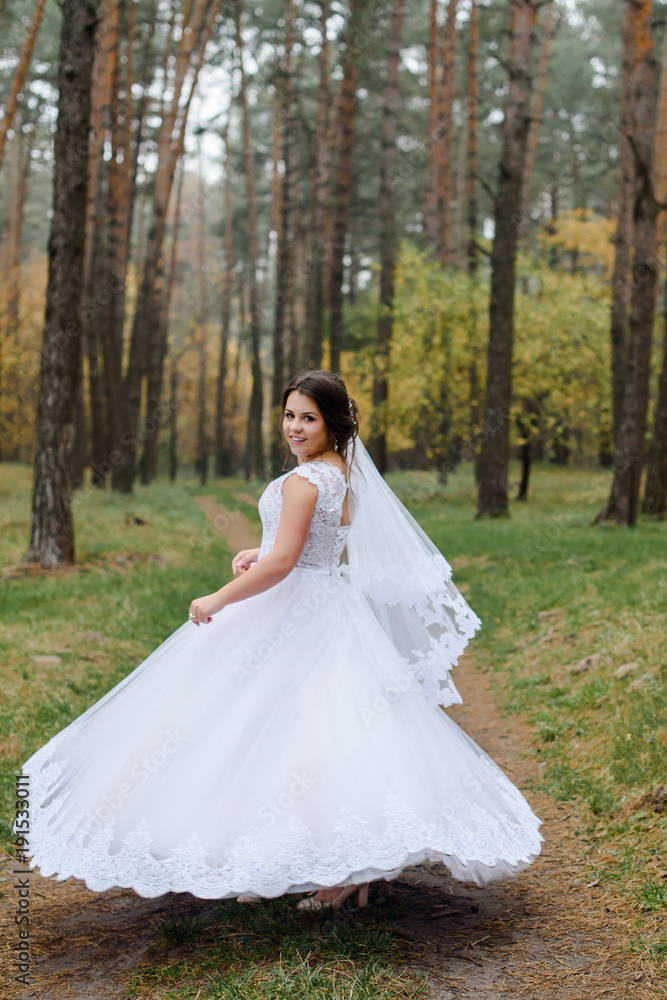 happy bride on autumn forest. young beauty bride with big eye