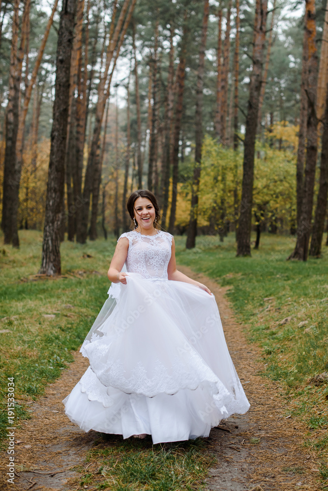 happy bride on autumn forest. young beauty bride with big eye happy bride on autumn forest. young beauty bride with big eye